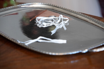elegant silver tray with wedding hairpin and ribbons on wooden surface