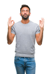 Adult hispanic man over isolated background relax and smiling with eyes closed doing meditation gesture with fingers. Yoga concept.