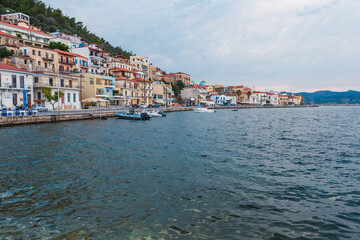 Fototapeta na wymiar waterfront promenade in a Mediterranean village with moored boats