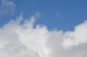 Clouds in a bright blue sky at midday - 781662204