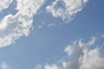 Clouds in a bright blue sky at midday - 781662215
