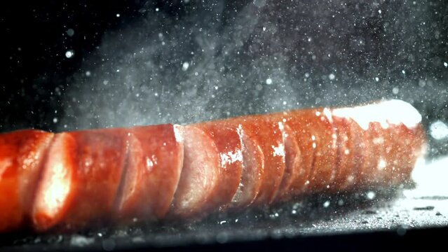 Super slow motion sausages are fried in a pan. High quality FullHD footage
