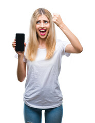 Young beautiful blonde woman showing smartphone over isolated background annoyed and frustrated shouting with anger, crazy and yelling with raised hand, anger concept