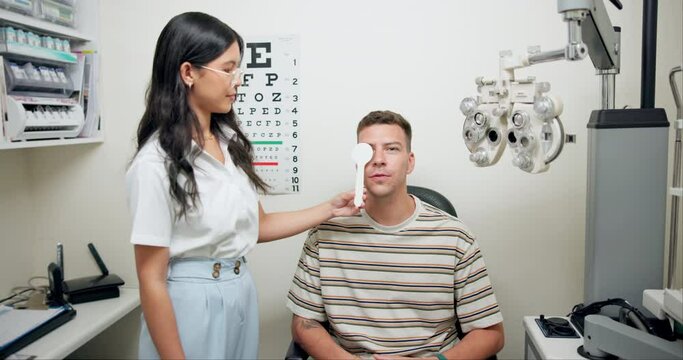 Man, doctor and eye testing with optometrist in office, vision or eyesight for glasses with professional holding occluder. Healthcare, sight examination in cover uncover, assessment and looking