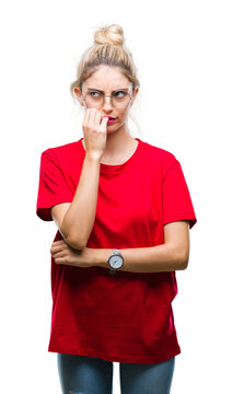 Young beautiful blonde woman wearing red t-shirt and glasses over isolated background looking stressed and nervous with hands on mouth biting nails. Anxiety problem.