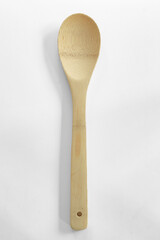 Wooden kitchen spoon on white
