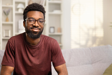 Smiling Young Man In Casual Home Setting Exuding Happiness And Confidence. Portrait Depicts Cheerfulness And Relaxed Lifestyle. Ideal For Ads, Magazines, And Positive Messaging.