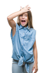 Young beautiful girl over isolated background surprised with hand on head for mistake, remember...