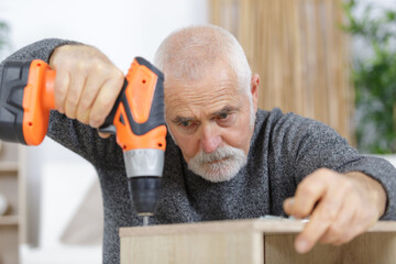 man with his tools leaning on a shelf - obrazy, fototapety, plakaty
