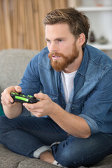 young man playing video games - obrazy, fototapety, plakaty