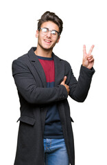 Young handsome elegant man wearing glasses over isolated background smiling with happy face winking...
