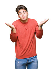Young handsome man over isolated background clueless and confused expression with arms and hands...