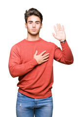 Young handsome man over isolated background Swearing with hand on chest and open palm, making a loyalty promise oath