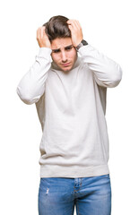 Fototapeta premium Young handsome man wearing turtleneck sweater over isolated background suffering from headache desperate and stressed because pain and migraine. Hands on head.