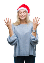 Young caucasian woman wearing christmas hat over isolated background celebrating mad and crazy for...