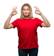 Young caucasian woman over isolated background relax and smiling with eyes closed doing meditation gesture with fingers. Yoga concept.