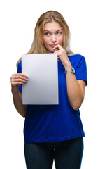 Young caucasian woman holding blank paper sheet over isolated background serious face thinking about question, very confused idea