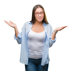 Young caucasian beautiful business woman wearing glasses over isolated background clueless and...