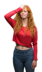 Young redhead woman stressed with hand on head, shocked with shame and surprise face, angry and frustrated. Fear and upset for mistake.