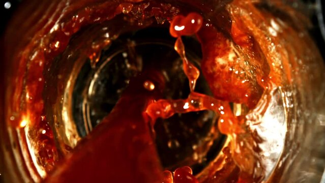 Captivating closeup shots of red liquid filling a glass, swirling dynamically. Vibrant colors create an engaging visual narrative, emphasizing fluid movements and the beauty of the liquid