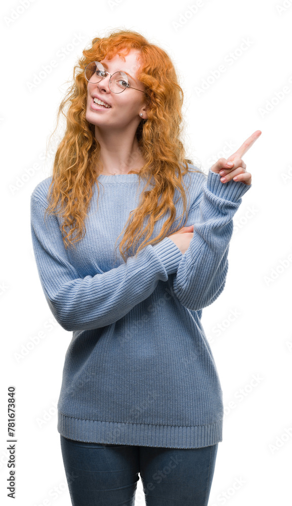 Sticker young redhead woman wearing glasses very happy pointing with hand and finger to the side