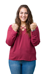 Beautiful plus size young woman over isolated background celebrating surprised and amazed for success with arms raised and open eyes. Winner concept.