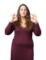 Beautiful and attractive plus size young woman wearing a dress over isolated background relax and smiling with eyes closed doing meditation gesture with fingers. Yoga concept.