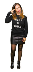 Beautiful middle age woman wearing rock and roll sweater Shooting and killing oneself pointing hand...
