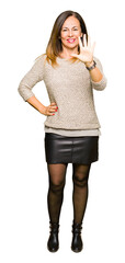 Beautiful middle age woman wearing fashion sweater showing and pointing up with fingers number five while smiling confident and happy.