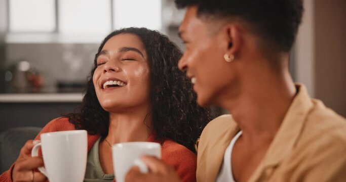Happy couple, morning and laughing with coffee for gossip, chat or funny conversation on living room sofa at home. Young man or woman enjoying talk, discussion or joke with beverage or drink at house