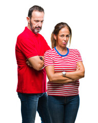 Middle age hispanic couple in love over isolated background skeptic and nervous, disapproving expression on face with crossed arms. Negative person.