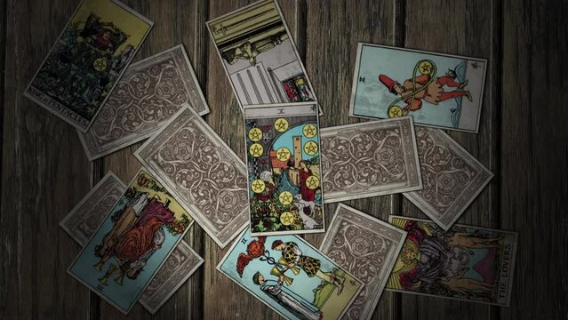 Paris, France - April 17, 2021. Ten Of Pentacles show an old man sitting with his two dogs by his feet dreaming of wealth. A Card brings dreams of wealth. Dreaming of becoming wealthy. Cartomancy.