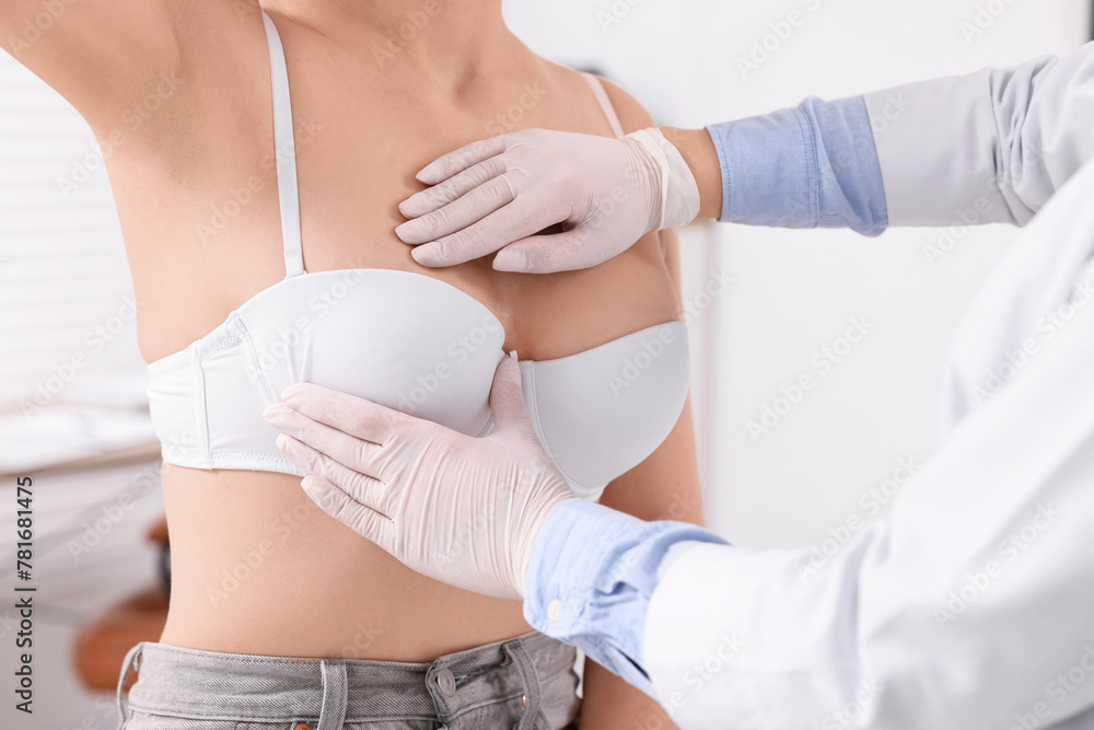 Wall mural Mammologist checking woman's breast in hospital, closeup