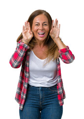 Beautiful middle age woman wearing over isolated background Trying to hear both hands on ear gesture, curious for gossip. Hearing problem, deaf - obrazy, fototapety, plakaty