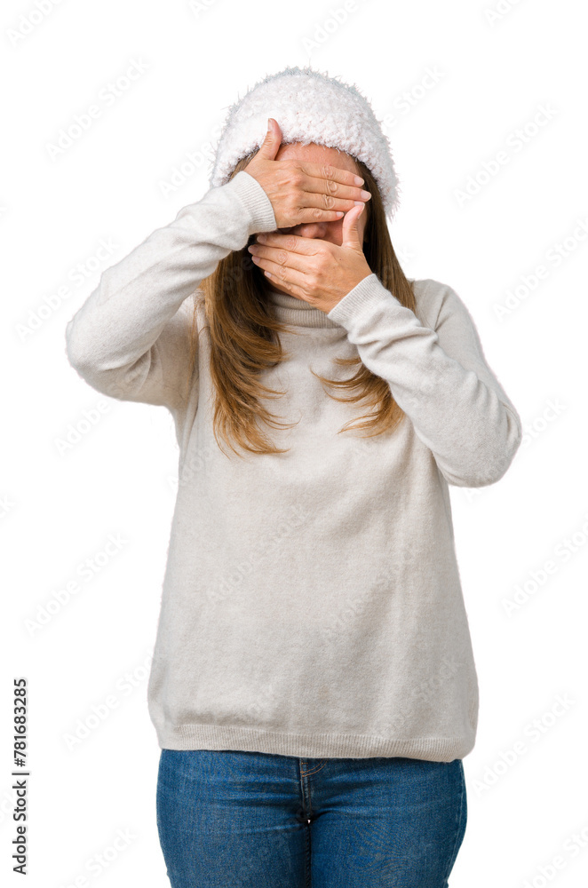 Poster Beautiful middle age woman wearing winter sweater and hat over isolated background Covering eyes and mouth with hands, surprised and shocked. Hiding emotion