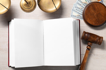 Tax law. Open book, gavel, dollar banknotes and scales on wooden table, flat lay