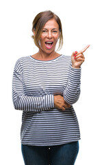 Middle age senior hispanic woman over isolated background with a big smile on face, pointing with hand and finger to the side looking at the camera.