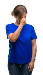 Middle age senior hispanic woman over isolated background tired rubbing nose and eyes feeling fatigue and headache. Stress and frustration concept.