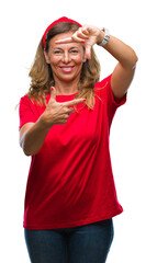 Middle age senior hispanic woman over isolated background smiling making frame with hands and fingers with happy face. Creativity and photography concept.