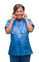 Middle age senior nurse doctor woman over isolated background covering ears with fingers with...