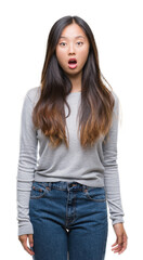 Young asian woman over isolated background afraid and shocked with surprise expression, fear and excited face.