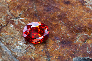 Red Ruby gemstone Round Cut on stone background, close up shot