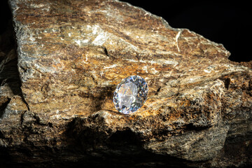 Diamond gemstone Round Cut on stone background, close up shot