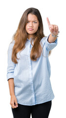 Young beautiful brunette business woman over isolated background Pointing with finger up and angry expression
