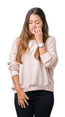 Young beautiful brunette woman wearing pink sweatshirt over isolated background looking stressed and nervous with hands on mouth biting nails. Anxiety problem.