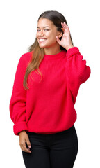 Young beautiful brunette woman wearing red winter sweater over isolated background smiling with...
