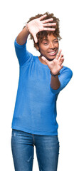Beautiful young african american woman over isolated background Smiling doing frame using hands palms and fingers, camera perspective