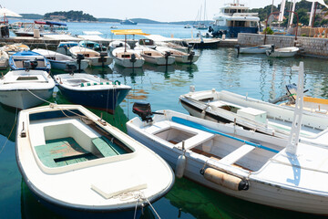 Group small open boats moored in bay Croatia - obrazy, fototapety, plakaty