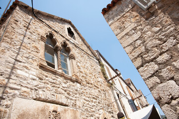 Stone construction and decorative detail of outside wall from low angle view. Croatia
