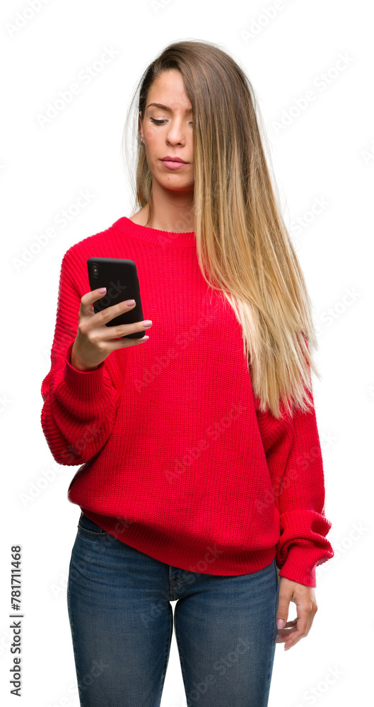 Wall mural Beautiful young woman using smartphone with a confident expression on smart face thinking serious